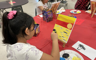 Students painting at La Plaza at Harney Elementary School